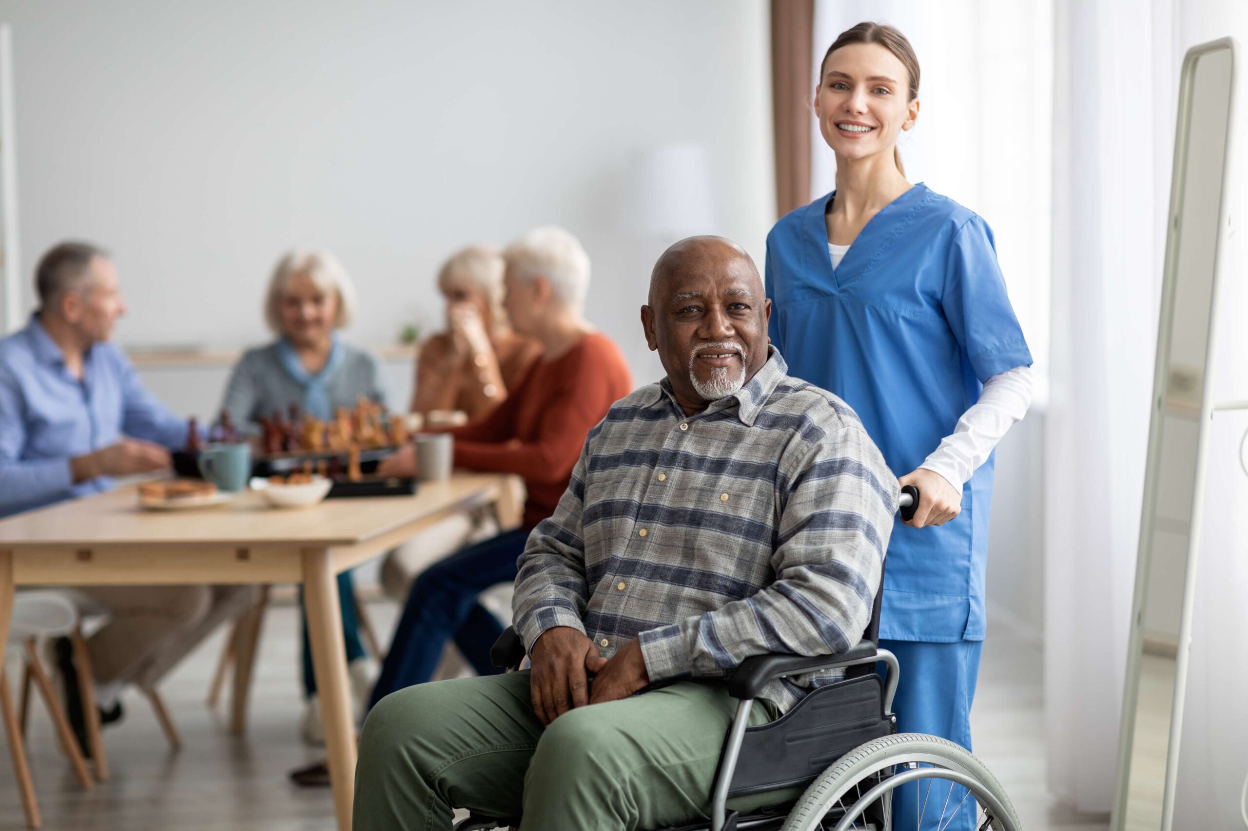 happy-older-patient-on-wheelchair-with-female-nurs-2022-12-16-07-20-28-utc
